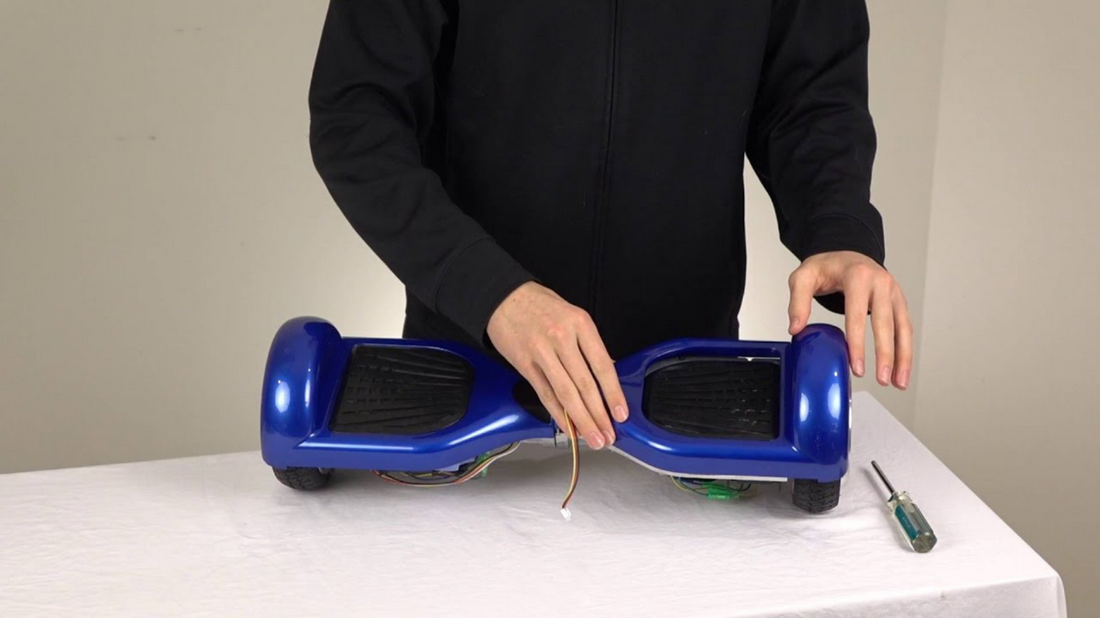 A blue hoverboard being held by a person on a table, and clean Rideo hoverboard.