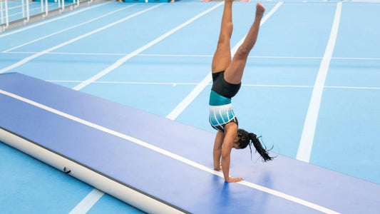 A gymnast performing a handstand on a Rideo Air mat, showcasing strength and balance in an impressive display of athleticism. Blog Image