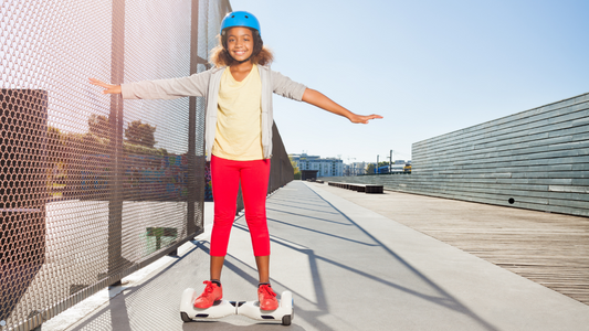 A young girl confidently rides a Rideo hoverboard in a park, showcasing her skills and passion for the sport.