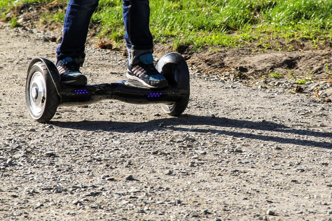 Legs of boy riding on self-balancing mini hoverboard in the off road rideo blog image