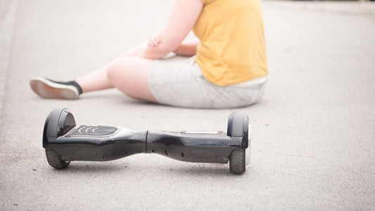 kid sitting on the ground with his Rideo hoverboard