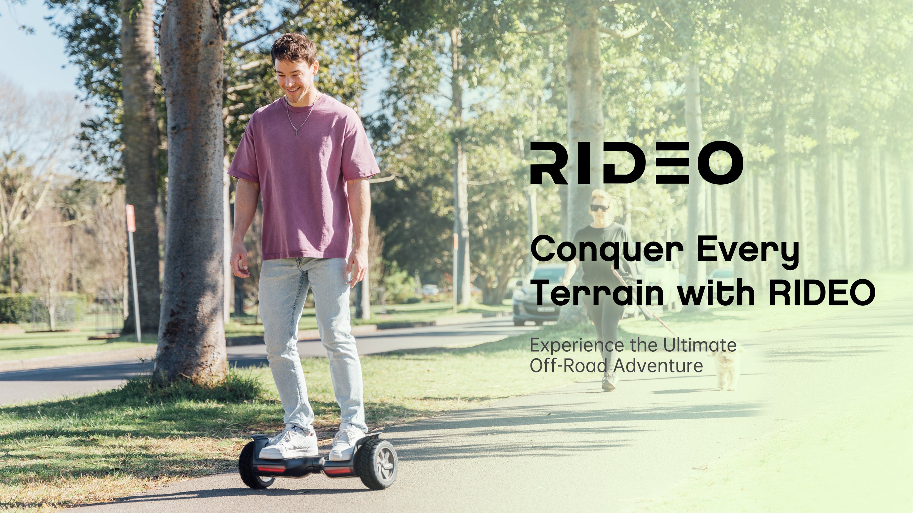 A man wearing a purple T-shirt is riding an All Terrain 8.5 inch Wheel hoverboard on the park pathway, showcasing his enjoyment and the joy of his ride.
