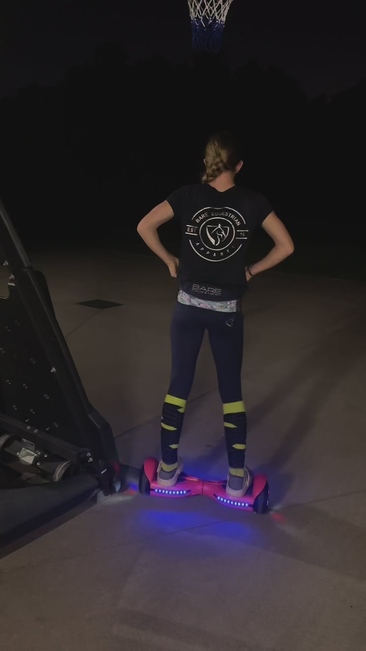 In the dim light, a girl skillfully rides hoverboard. The scene captures her joyful moments, showcasing her basketball skills and playful interactions with her pet. A perfect blend of fun and companionship.