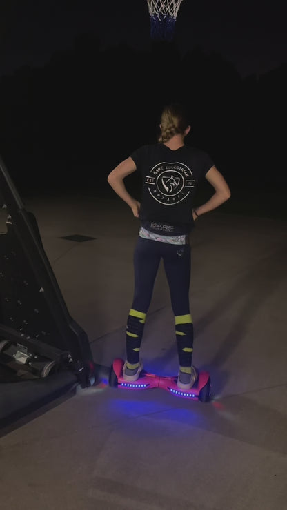 In the dim light, a girl skillfully rides hoverboard. The scene captures her joyful moments, showcasing her basketball skills and playful interactions with her pet. A perfect blend of fun and companionship.